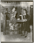 Mae West and unidentified actor (holding boxes) in the stage production Diamond Lil