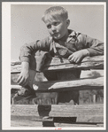Farm boy resting on rail fence. San Augustine County, Texas