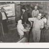 Looking at cow's teeth in auction barn. San Augustine, Texas