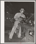 Threading a pipe at blacksmith shop. San Augustine, Texas