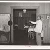 Negro factorum ringing bell for dinner. Hotel, San Augustine, Texas