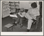 Trying on a new pair of shoes. San Augustine, Texas