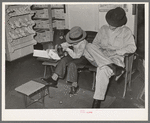 Trying on a new pair of shoes. San Augustine, Texas