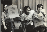 Lavender Menace members hold signs reading "The women's movement is a lesbian plot"