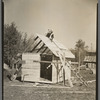 Orville White building a small shed on his farm near Northome, Minnesota