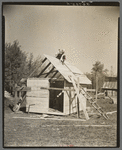 Orville White building a small shed on his farm near Northome, Minnesota