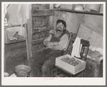 Father of beet worker family resting after a day's work, East Grand Forks, Minnesota