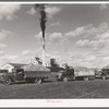 Trucks loaded with sugar beets, factory in background, East Grand Forks, Minnesota