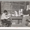 Mother and son in combined, kitchen, living room and bedroom, beet workers near Fisher, Minnesota