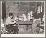 Mother and son in combined, kitchen, living room and bedroom, beet workers near Fisher, Minnesota