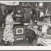 Mrs. Ole Thompson, wife of farmer, carrying food to the table, Williams County, North Dakota