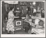 Mrs. Ole Thompson, wife of farmer, carrying food to the table, Williams County, North Dakota