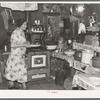 Mrs. Ole Thompson, wife of farmer, carrying food to the table, Williams County, North Dakota