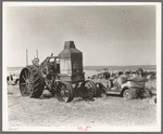 Old auto and Advance Rumley tractor in junkyard at Wildrose, North Dakota. Tractor cost six or seven thousand dollars and burned. A mixture of about fifty percent kerosene and fifty percent water. The water was added to keep the valves from overheating