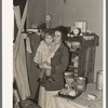 Mother and child in corner of farm home, Sheridan County, Montana