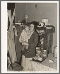 Mother and child in corner of farm home, Sheridan County, Montana