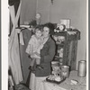 Mother and child in corner of farm home, Sheridan County, Montana