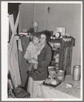 Mother and child in corner of farm home, Sheridan County, Montana