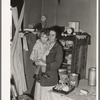 Mother and child in corner of farm home, Sheridan County, Montana