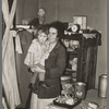 Mother and child in corner of farm home, Sheridan County, Montana