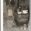 Kitchen stove and bag full of cow dung used as fuel, Sheridan County, Montana