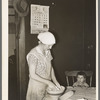 Mrs. Baker, wife of farmer, kneading dough near Ambrose, North Dakota