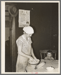 Mrs. Baker, wife of farmer, kneading dough near Ambrose, North Dakota