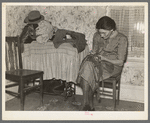 Mrs. Gallagher patching clothes for her children. Wife of former farmer, now living in Crosby, North Dakota
