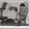 Mrs. Gallagher patching clothes for her children. Wife of former farmer, now living in Crosby, North Dakota