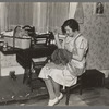 Mrs. Carl Thorson patching clothes in home, Crosby, North Dakota
