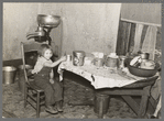 Daughter of John Baker in kitchen of the farm home, Divide County, North Dakota