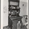 Baby in front of dresser in John Baker's farm home, Divide County, North Dakota