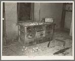 Chemical cabinet in assaying office at Two Bit Creek. Note the cupels for accommodating sample ore, South Dakota