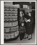 Resident at Greenbelt with child in the Greenbelt cooperative grocery store, Maryland