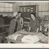 Southeast Missouri Farms. Customers examining yard goods in cooperative store. La Forge project, Missouri