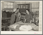 Southeast Missouri Farms. Customers examining yard goods in cooperative store. La Forge project, Missouri