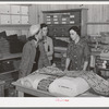 Southeast Missouri Farms. Customers examining yard goods in cooperative store. La Forge project, Missouri