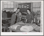 Southeast Missouri Farms. Customers examining yard goods in cooperative store. La Forge project, Missouri