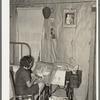 Southeast Missouri Farms. Girl making a hooked rug in bedroom of shack home, La Forge, Missouri