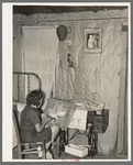 Southeast Missouri Farms. Girl making a hooked rug in bedroom of shack home, La Forge, Missouri