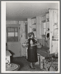 Southeast Missouri Farms. Wife of client in kitchen of new home, La Forge project, Missouri