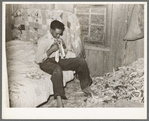 Southeast Missouri Farms. Son of sharecropper dressing in combination bedroom and corn crib