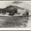 Member of carnival crew resting on hammock. Lasses-White traveling show, Sikeston, Missouri