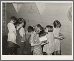 Children choosing books from the small school library near La Forge, Missouri. Southeast Missouri Farms school