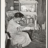 Resident of Tin Town, Caruthersville, Missouri, sitting at kitchen table