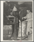 Sewing bag of rice brand after being weighed in rice packaging process, Crowley, Louisiana