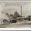 Burning pile of sawdust at sawmill at Wells, Texas
