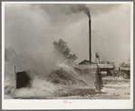 Burning pile of sawdust at sawmill at Wells, Texas