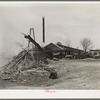 Sawmill and waste lumber pile being burned. Wells, Texas
