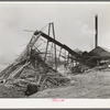 Sawmill and waste lumber pile being burned. Wells, Texas